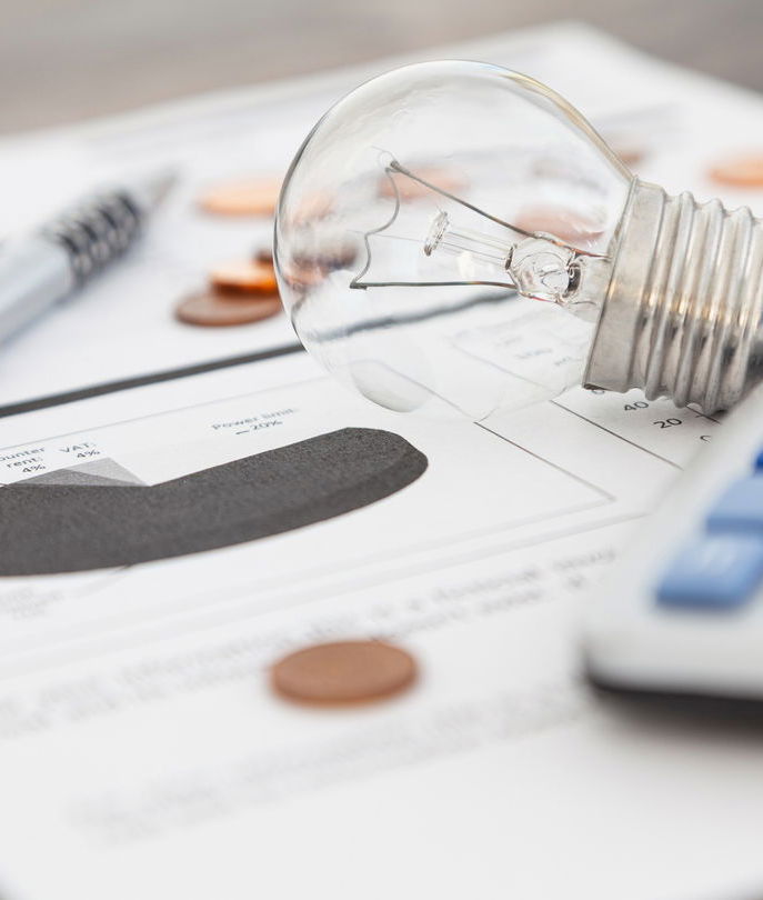 Electric bill with calculator and light bulb on top