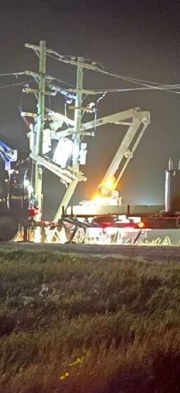 Repair truck and crew make repairs at night