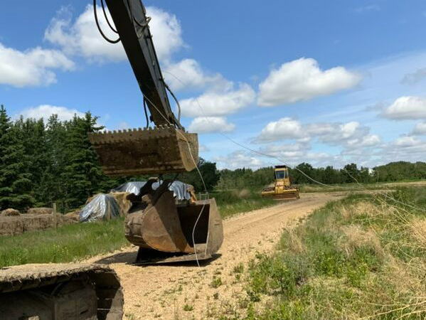 power lines tangled on backhoe