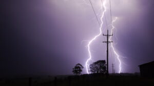 Lightning behind a power pole